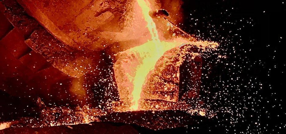 Molten metal showering glowing embers